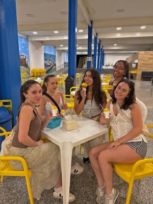 people sitting around a table enjoying ice cream