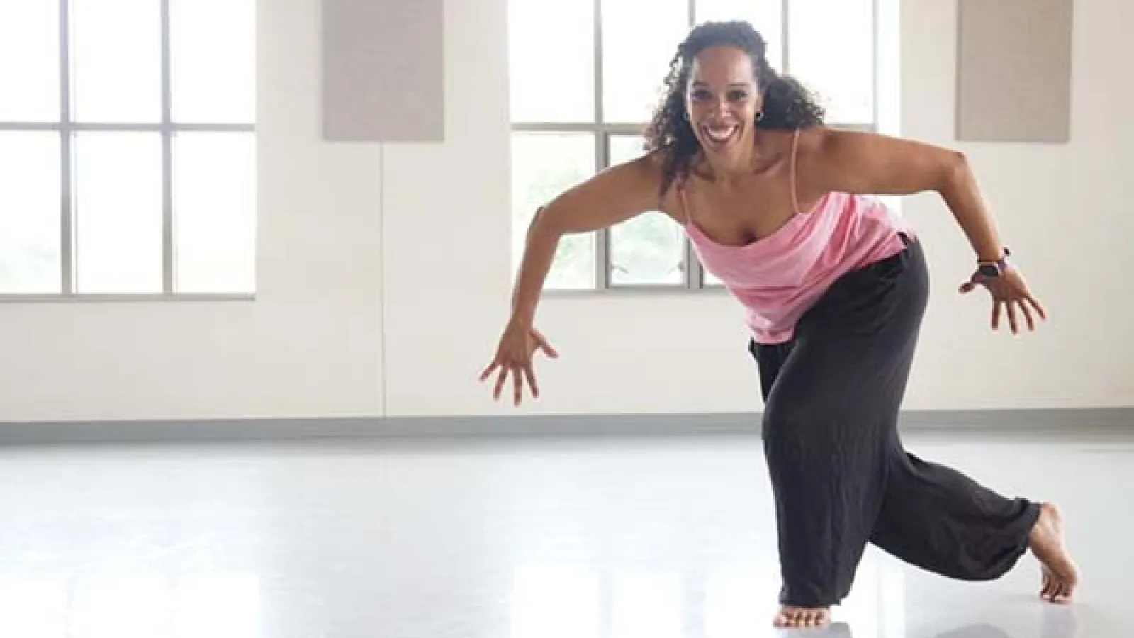 Dr. Nyama McCarthy-Brown dancing in a studio. 