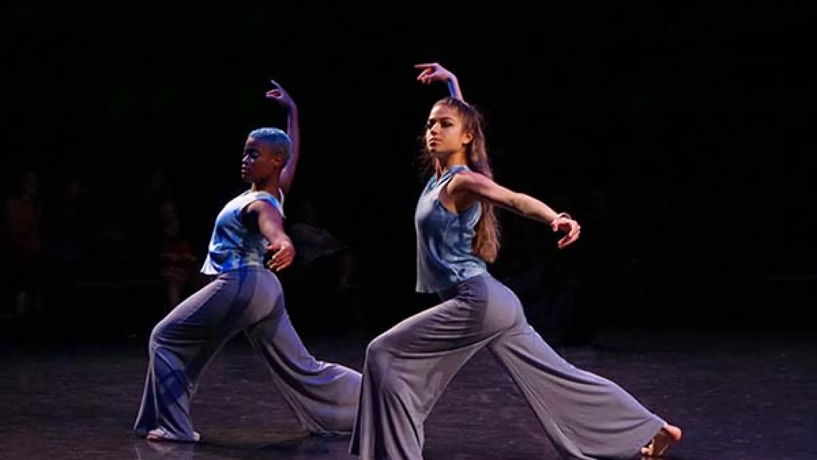 2 dancers on stage performing