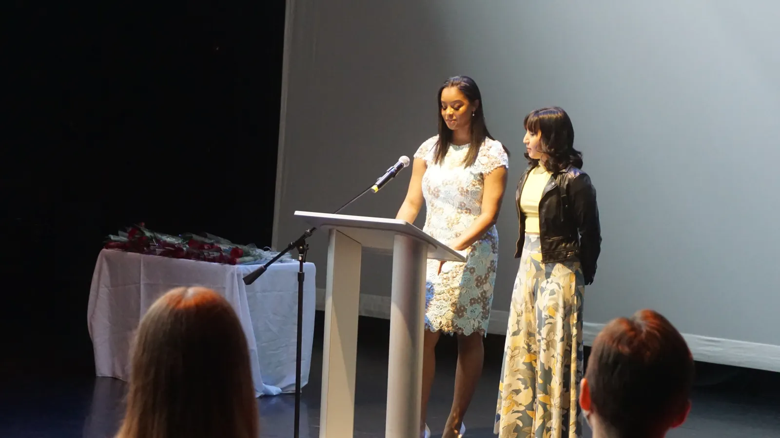 Students speaking at a podium