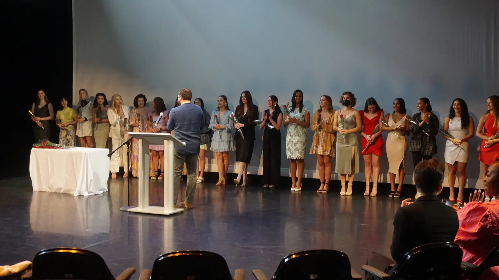 Students standing on a stage 