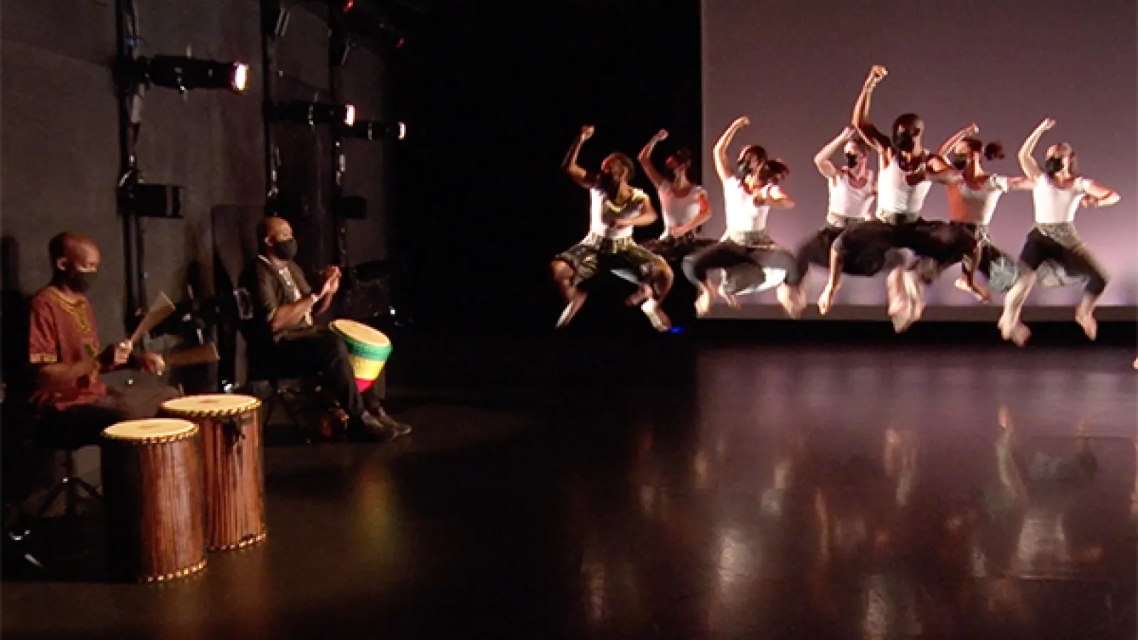 Drummers and dancers performing on stage