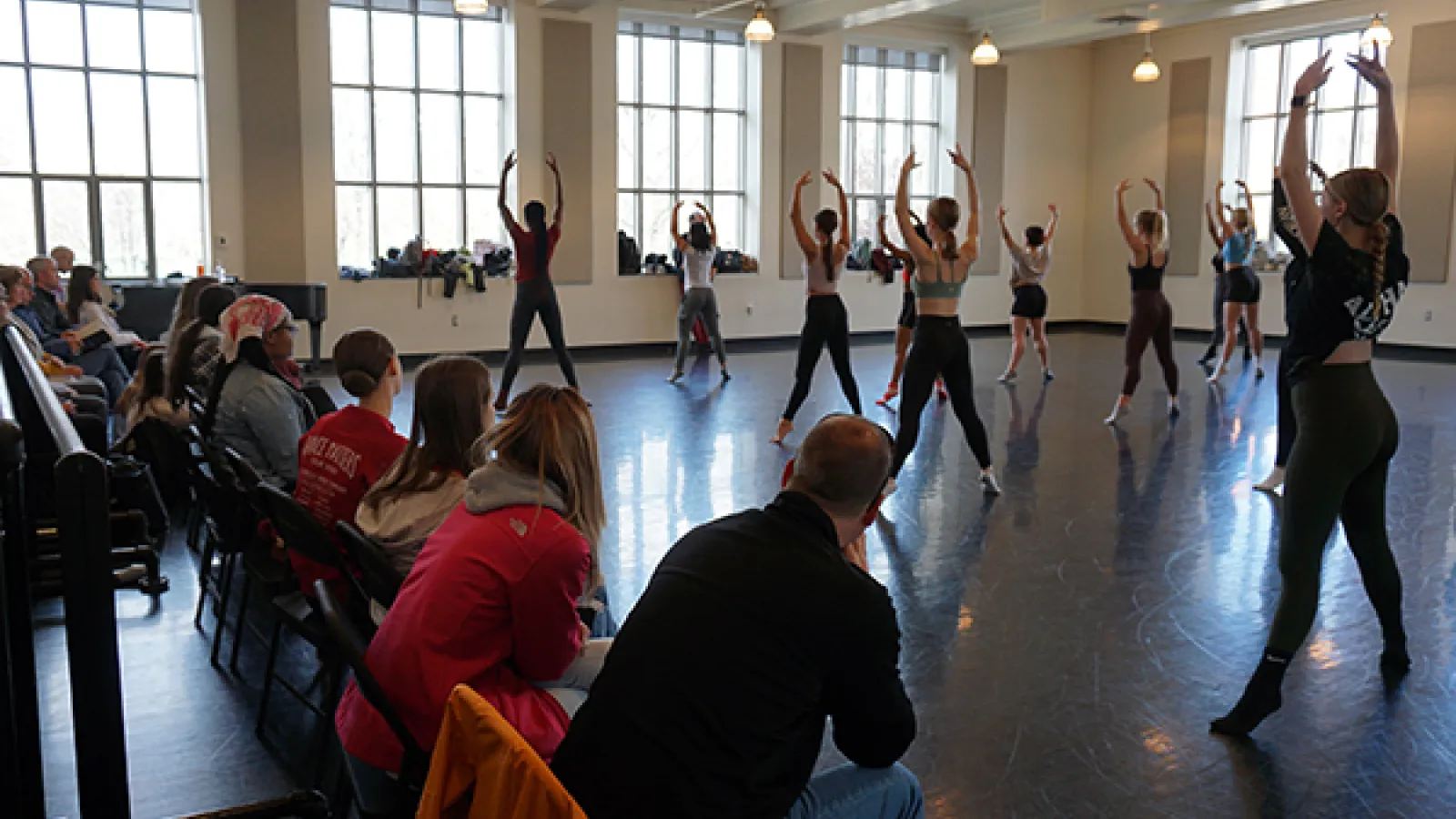 Dancers rehearsing in a studio with audience 