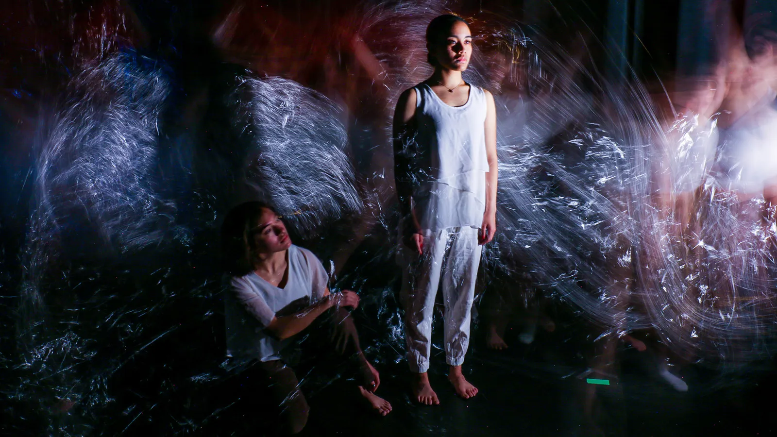 Dancers performing in front of video screen