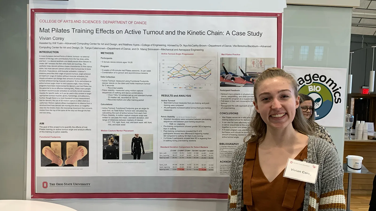 Woman standing next to poster