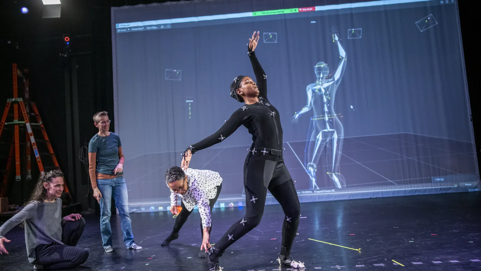 Faculty watching dancer in a motion capture studio