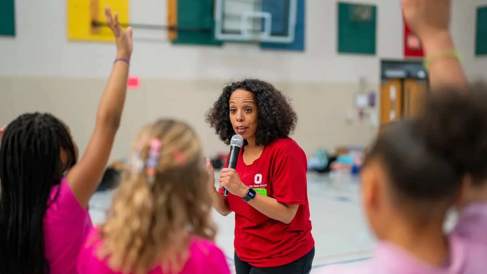 Dance instructor teaching students in a gym