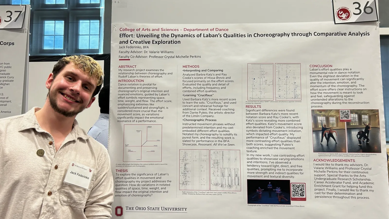 Student posing with research poster.