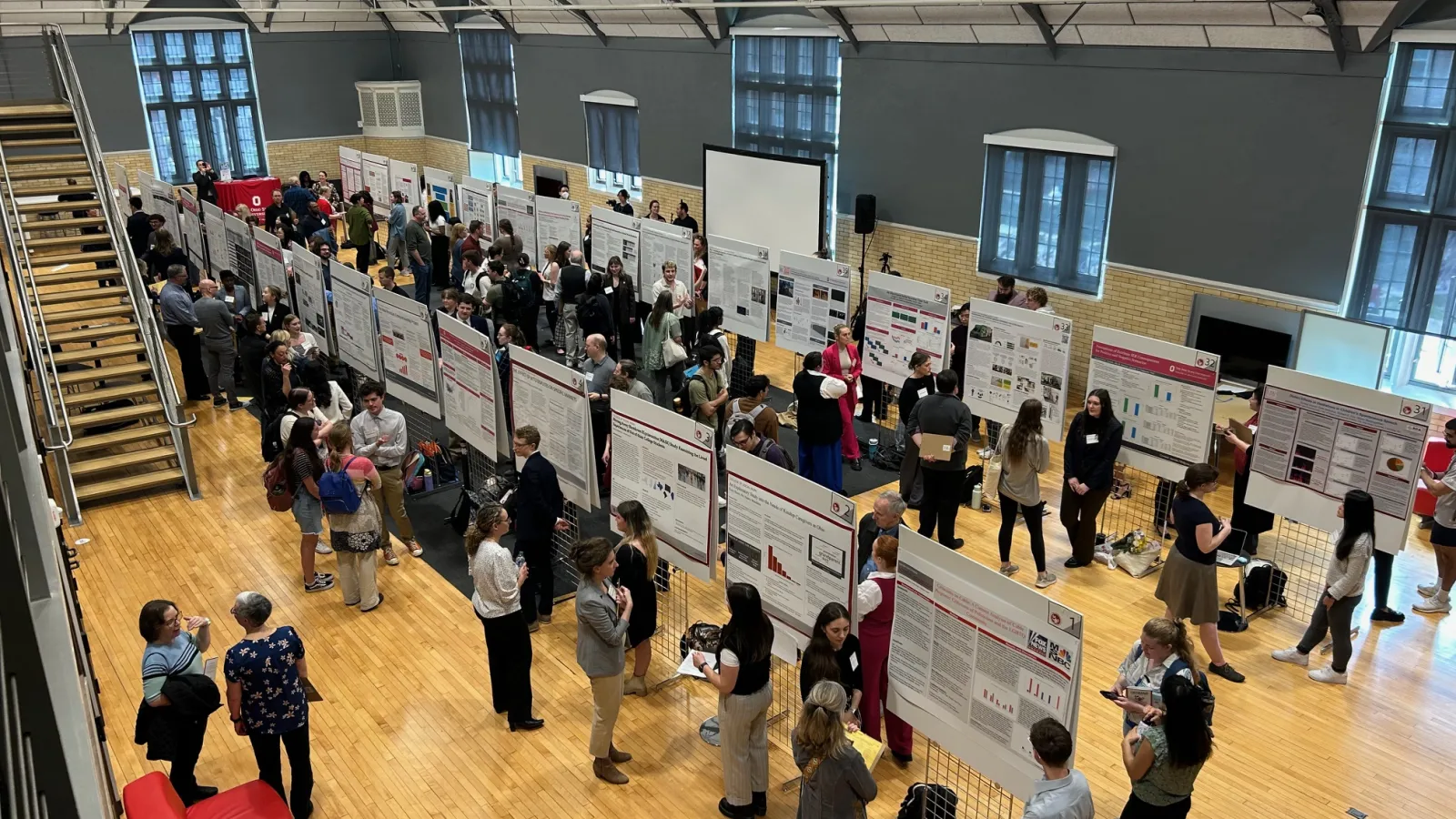 Student posing with research poster.