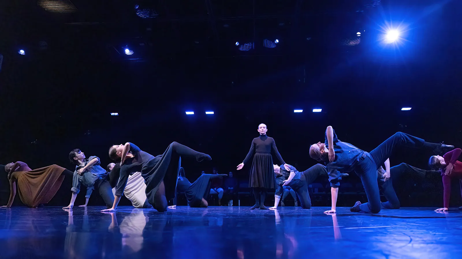 dancers in earth tone costumes on a stage