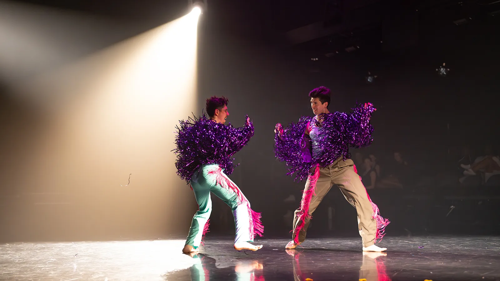 two dancers on a lit stage