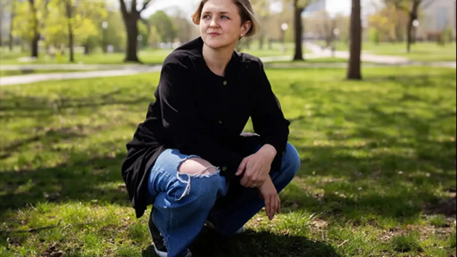 Person crouching on grass