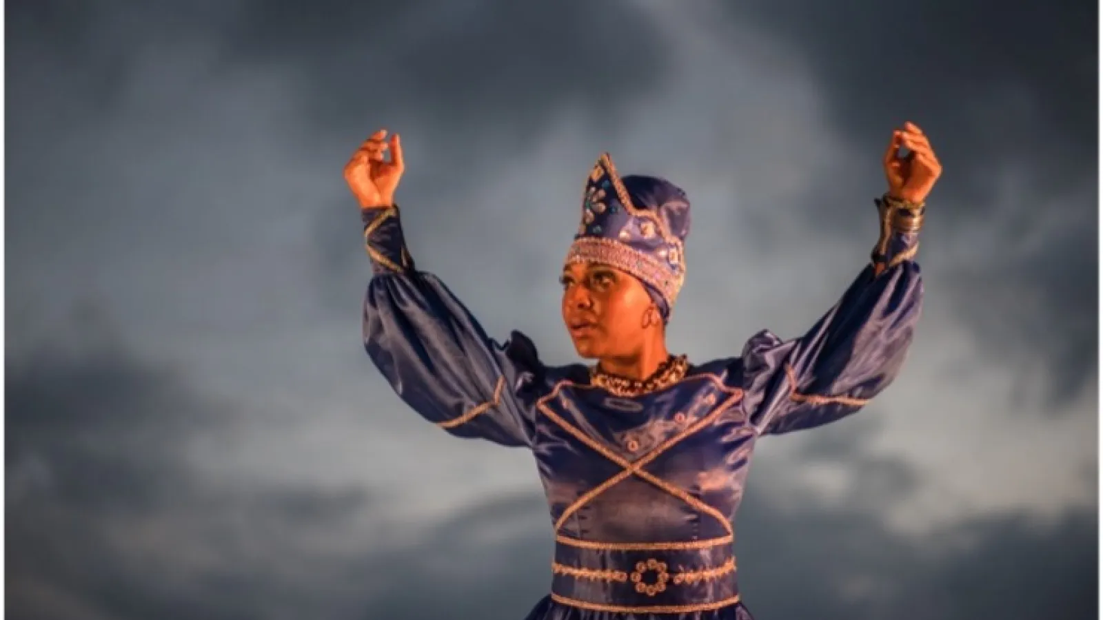 Dancer with arms raised