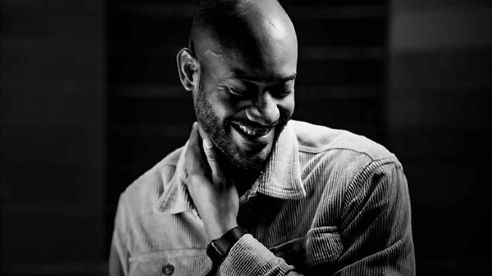 Headshot of bald man wearing dress shirt