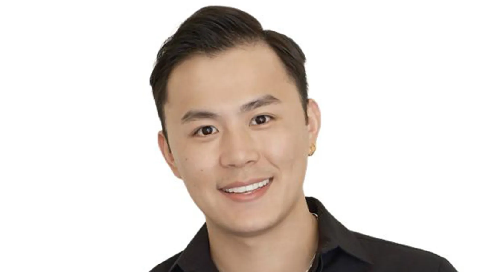 A headshot of a man with short black hair