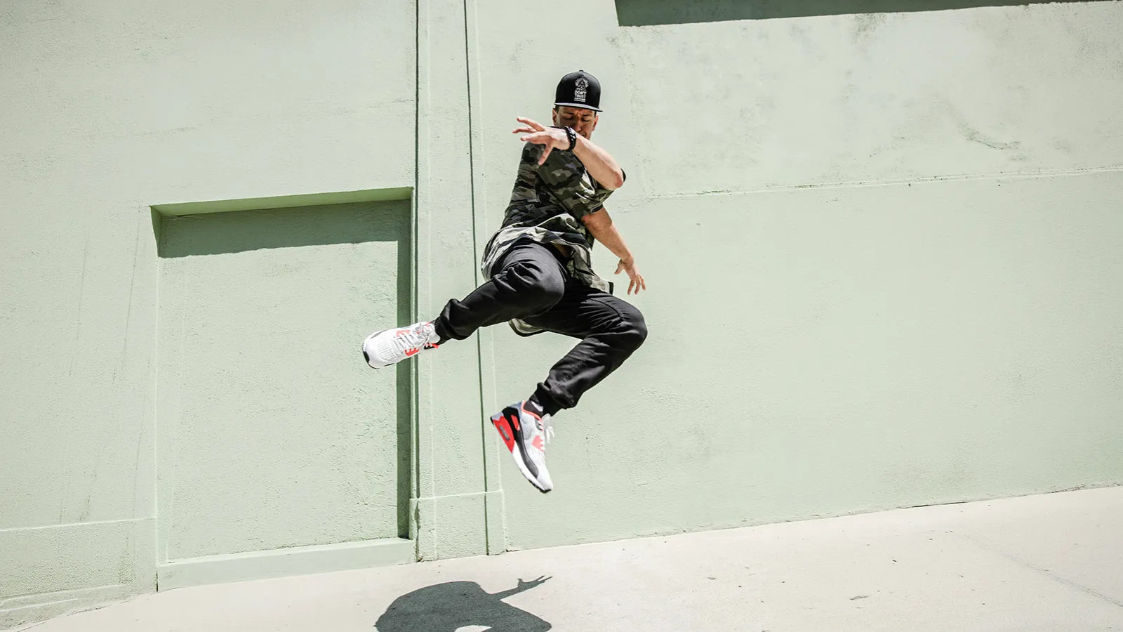 Dancer jumping in the air on a sidewalk