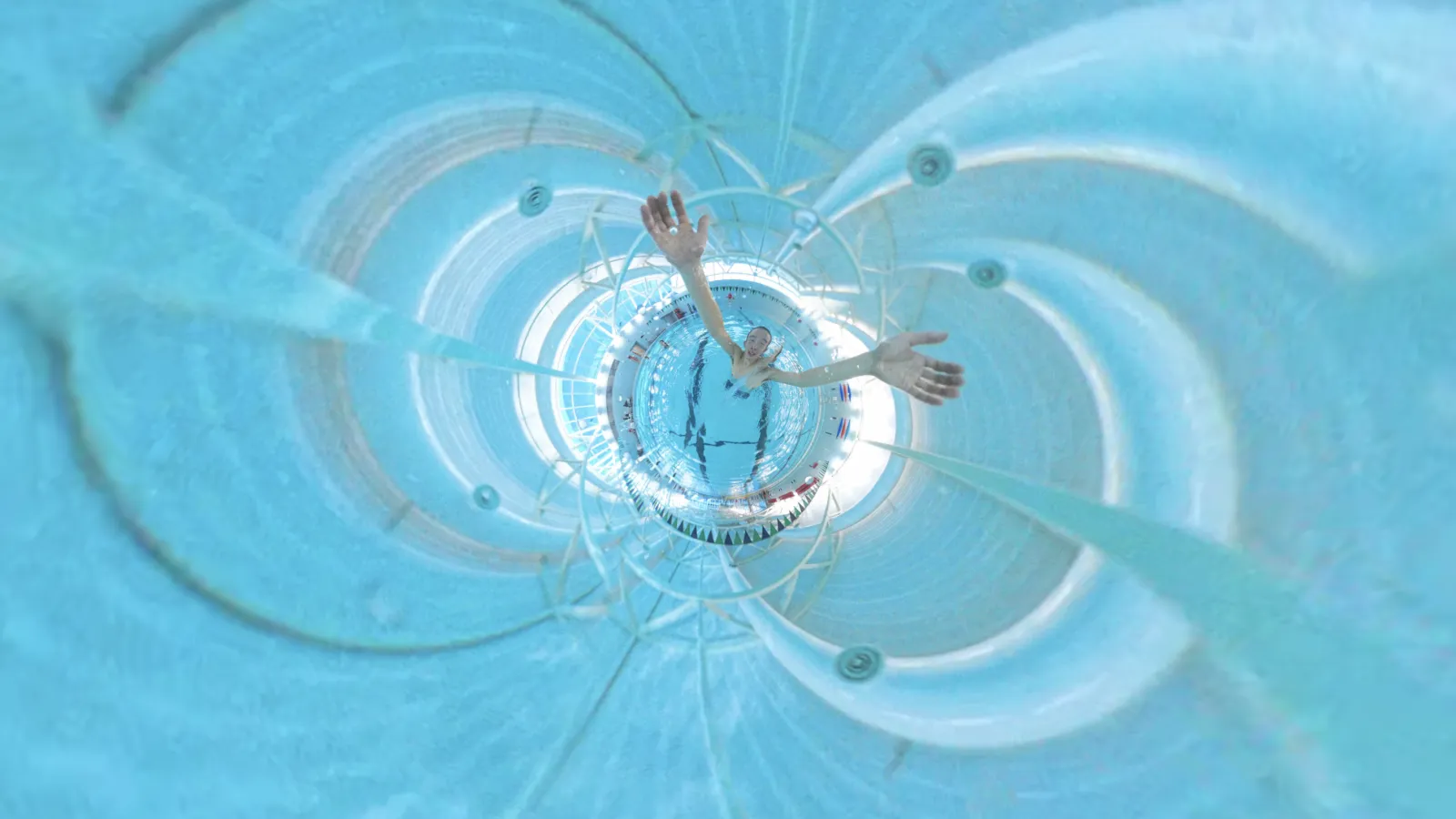 Edited still of swimmer with arms extended in a pool 