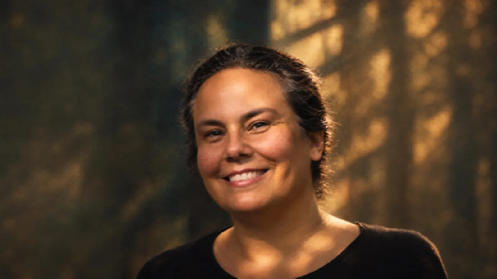 Headshot of a woman with shadows in the background 