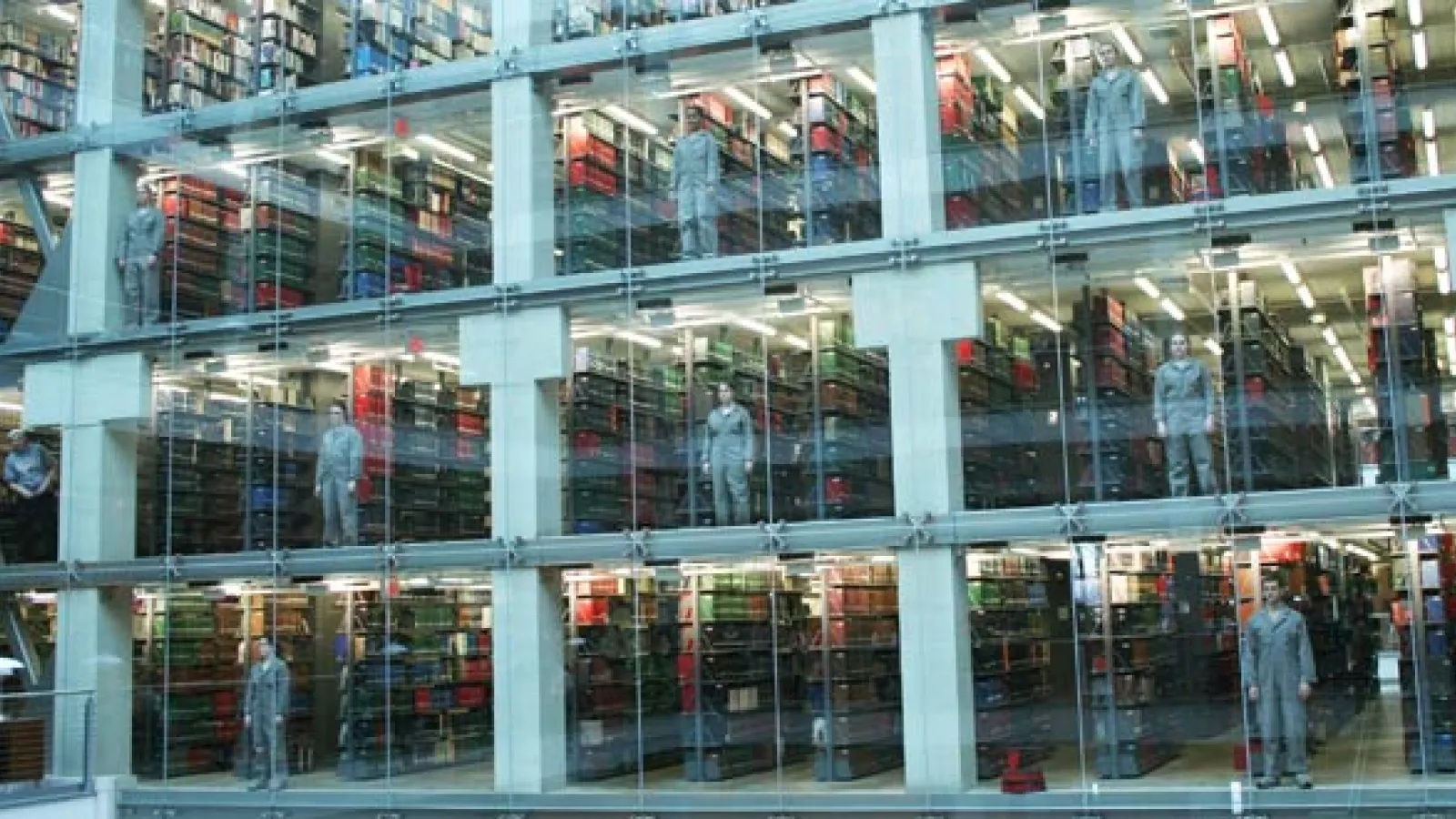 Students stand in the atrium windows of Thompson Library just before a performance starts.
