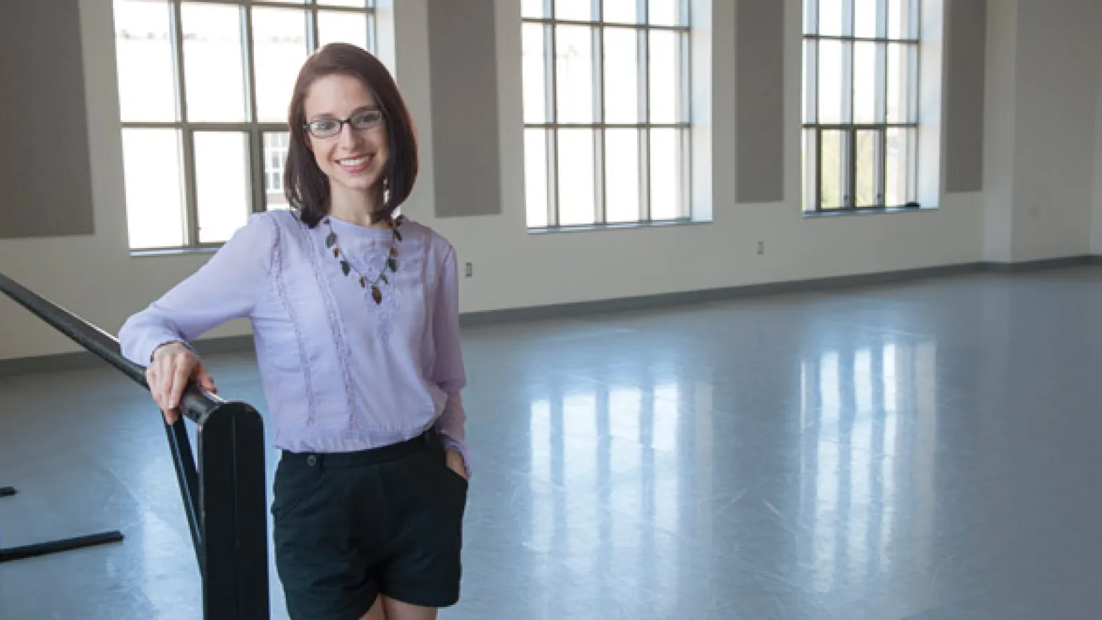 Lauren Bedal in front of windows in one of the Department's studios.