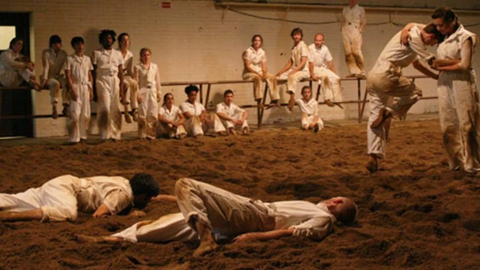 Our Town, an original work by Bebe Miller, a dirt covered stage filled with dancers.