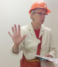 Susan Petry in a hardhat talking to someone off camera.