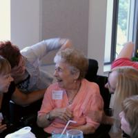 Helen Alkire surrounded by friends at the Alumni Reunion.