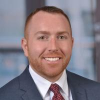 person with short hair wearing a suit