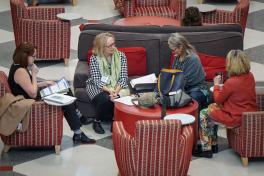 Conference Local Arrangements Committee Member and Professor Emerita Candace Feck (center) and Professor Emerita Melanie Bales (right) chatting in the Ohio Union lobby. Photo by Jess Cavender. 