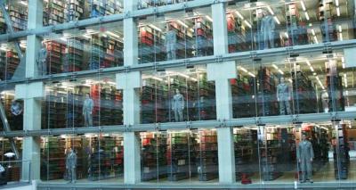 Students stand in the atrium windows of Thompson Library just before a performance starts.