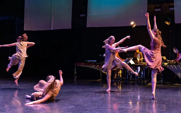 Dancers and musicians performing on a stage