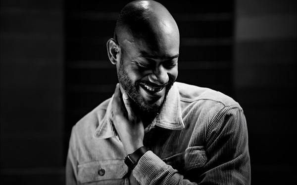 grayscale photo of smiling bald man