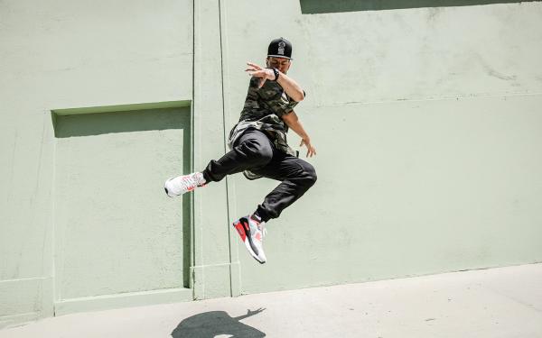 Dancer jumping in the air on a sidewalk