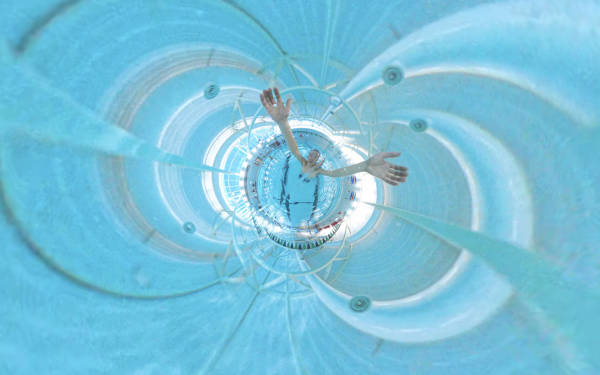 Edited still of swimmer with arms extended in a pool 
