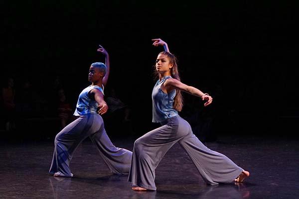 2 dancers on stage performing