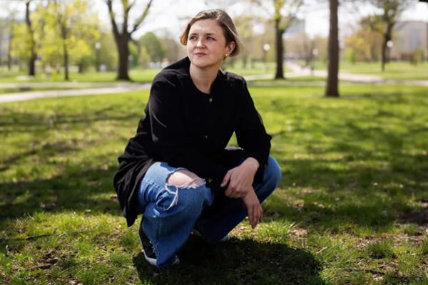 Person crouching on grass