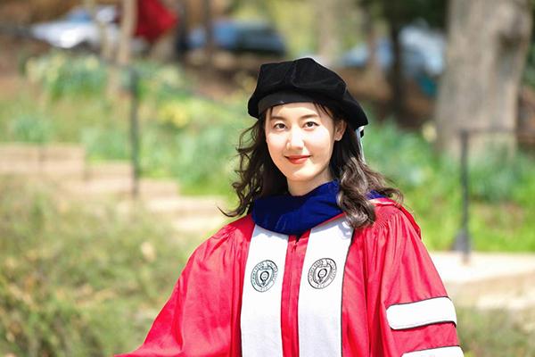 Person in red graduation gown