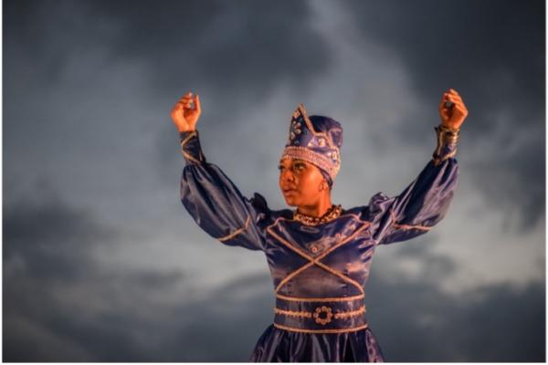 Dancer with arms raised