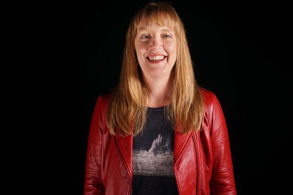 person with long red hair wearing red jacket