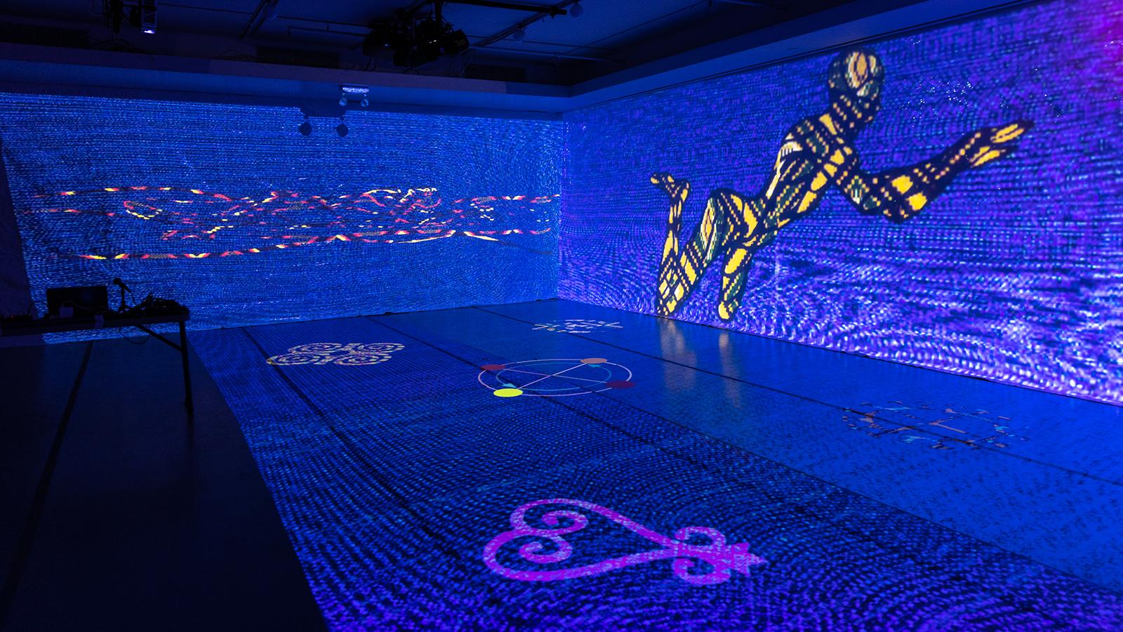 A digital image on a screen of a dancer moving through a blue space 