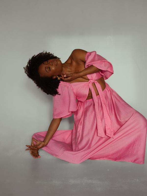 Afaliah Tribune posing in Pink Dress. Photo by Rebecca Oviatt