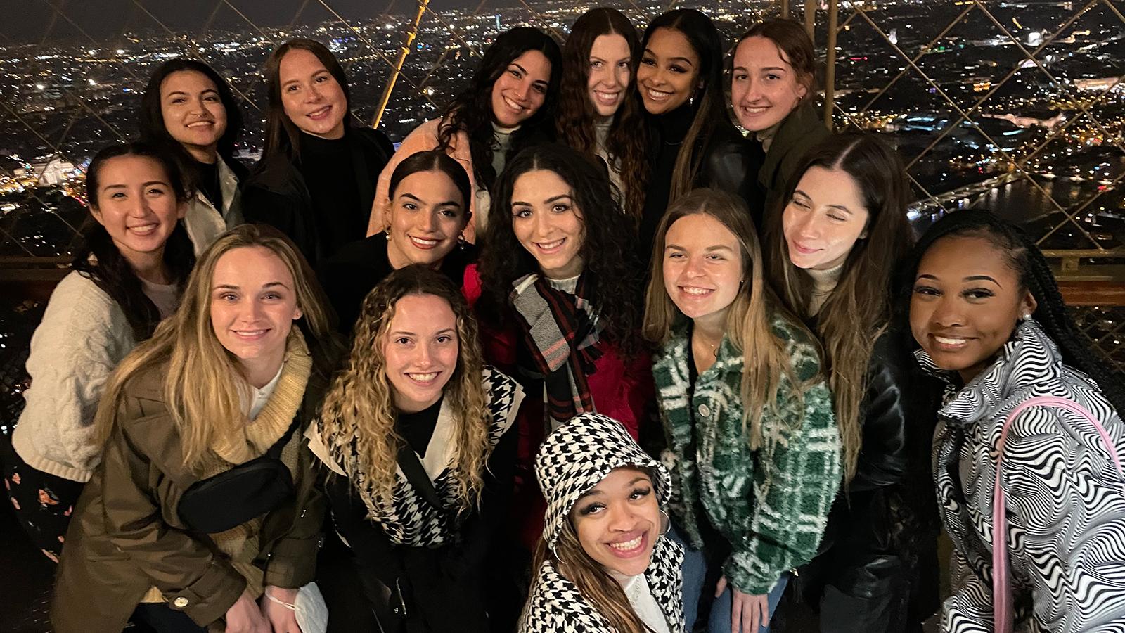 Women posing with Paris in the background 