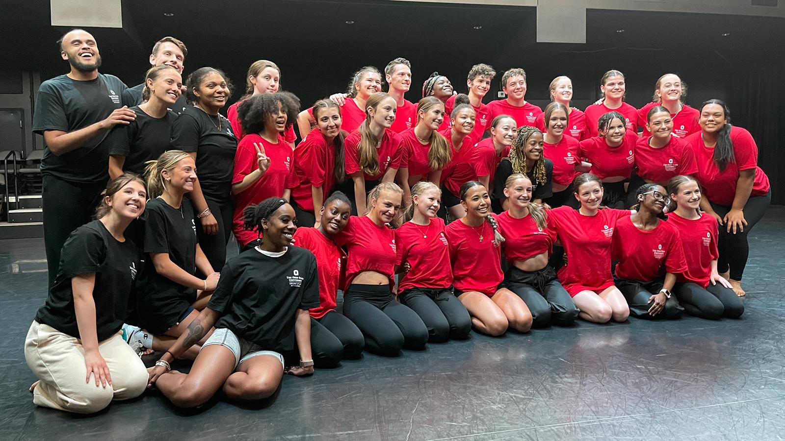 Group photo of dancers in black and red t-shirts 