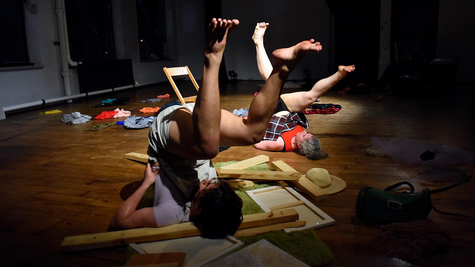 people laying on backs on cluttered floor