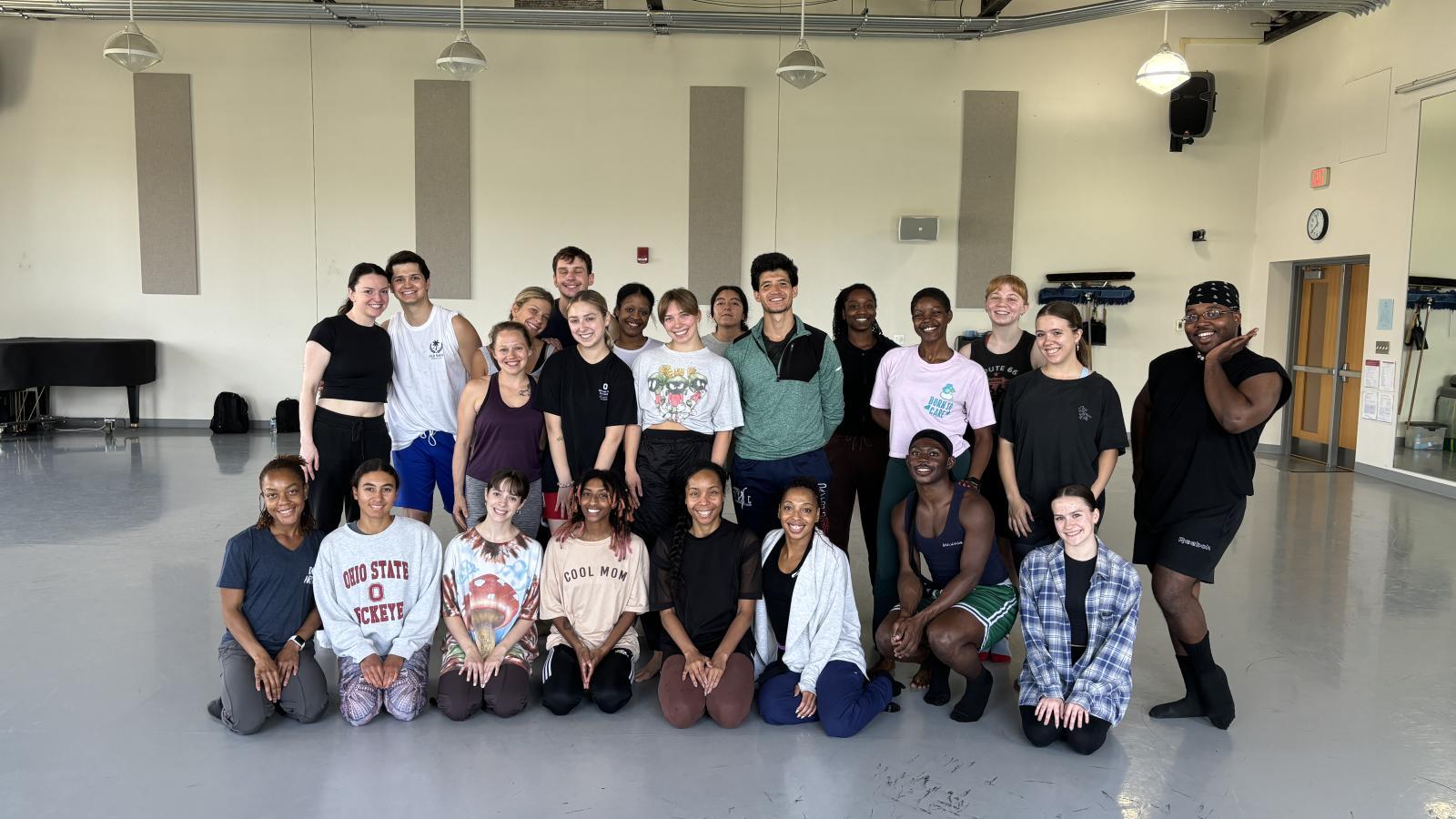 Dancers posing for a  group photo in a studio