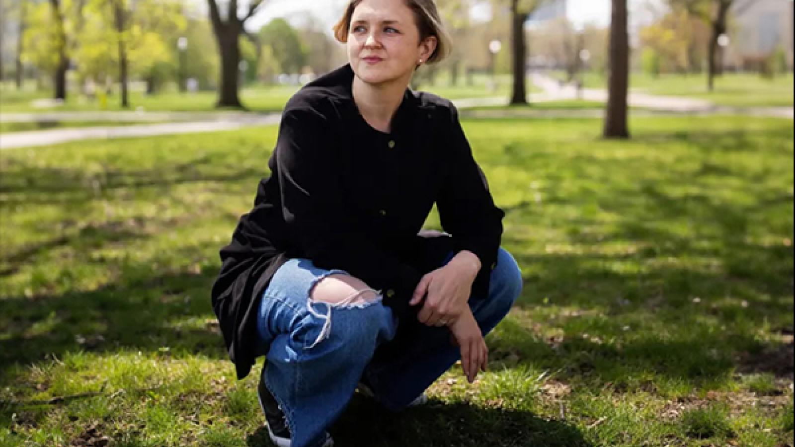 Person crouching on grass
