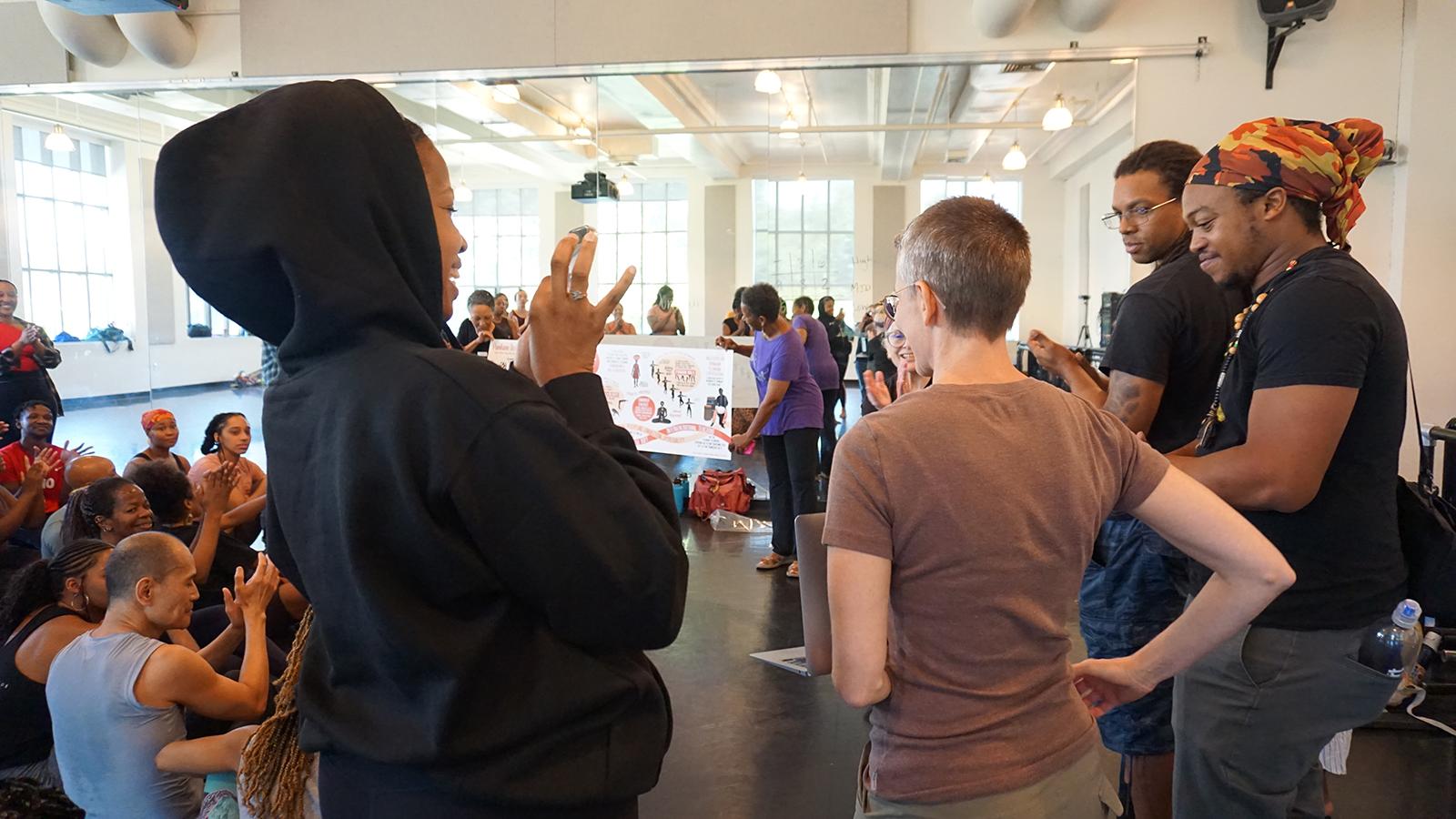 Dancers looking at a large banner