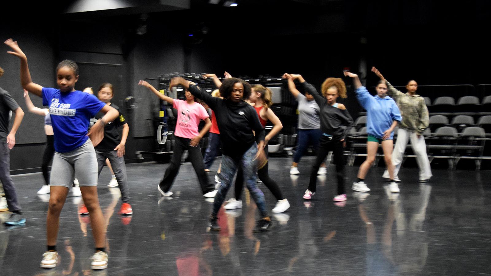 Dancers rehearsing in a theatre