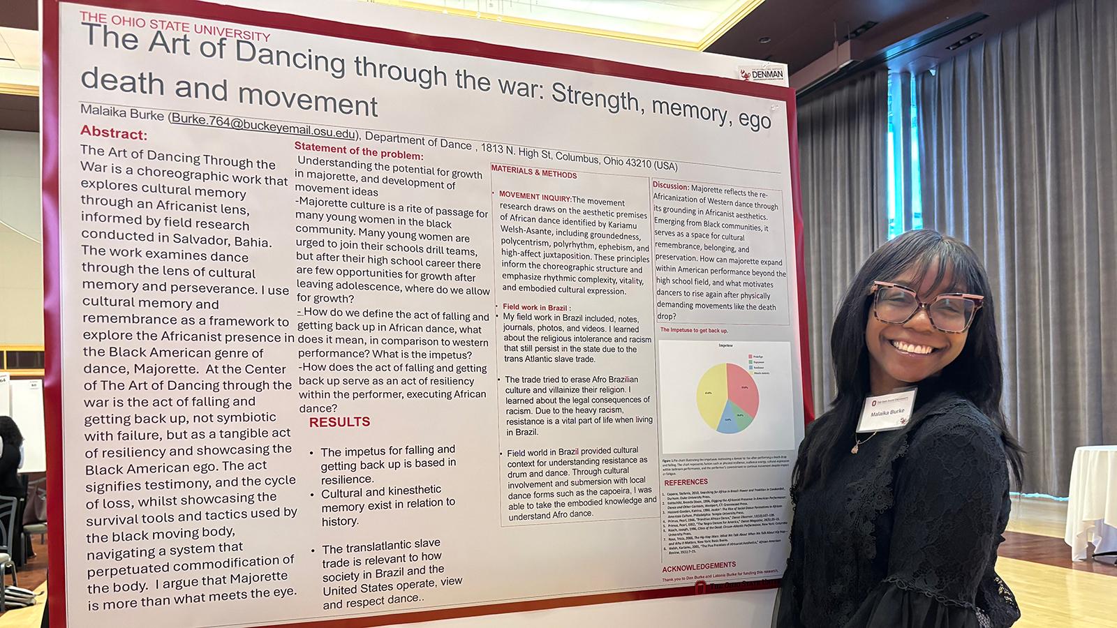 Woman standing next to a poster