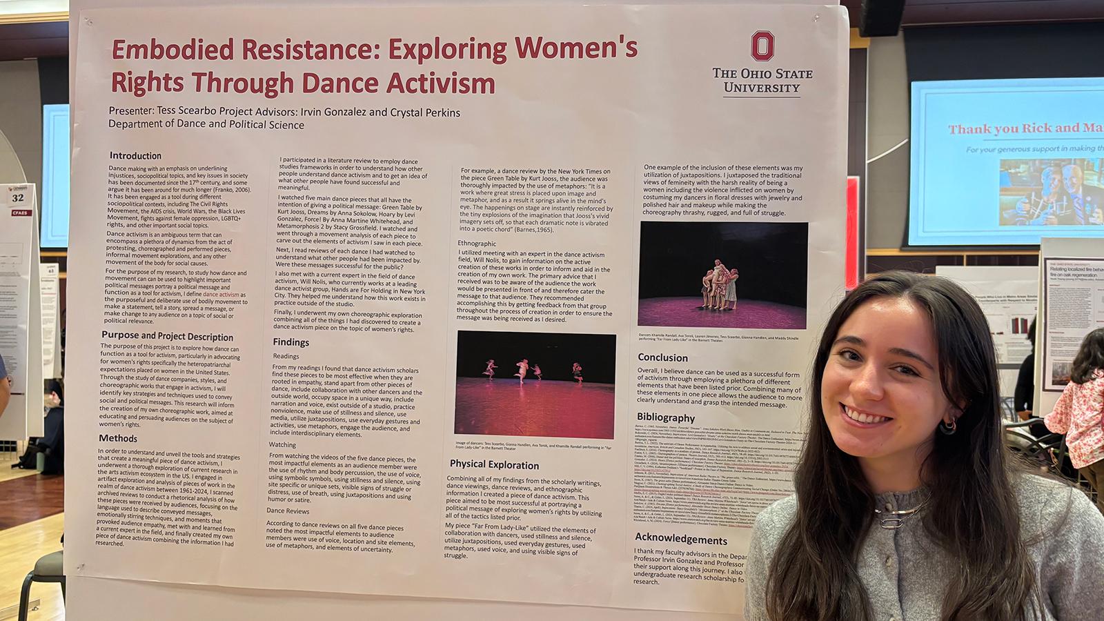 Woman standing next to a poster